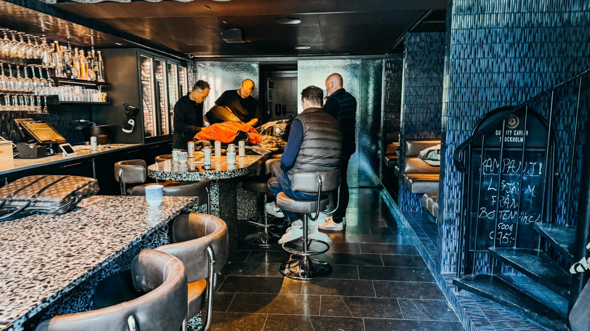 Men hanging out inside the Quality Caviar Stockholm store