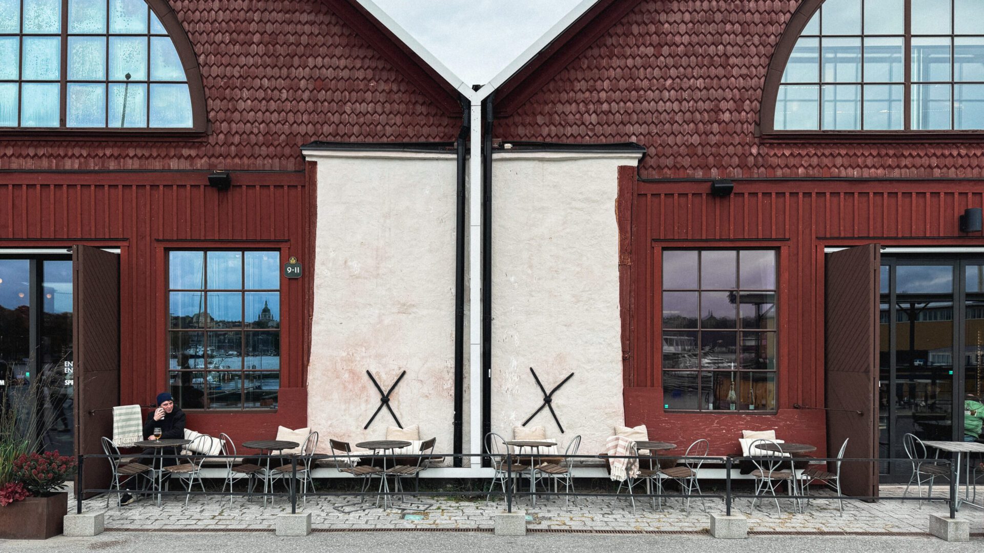 Red brick exterior of a building with a seating area