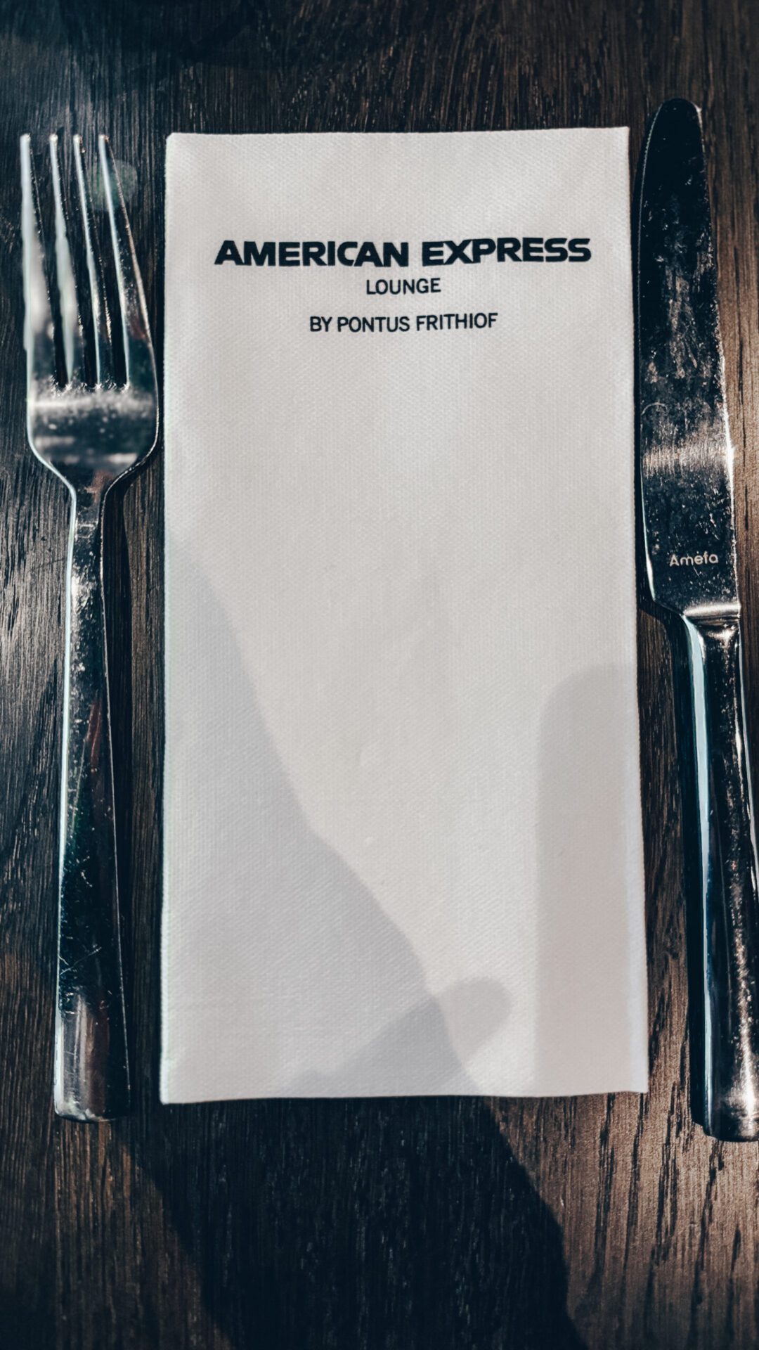 Fork, knife and napkin with the name of the lounge on it