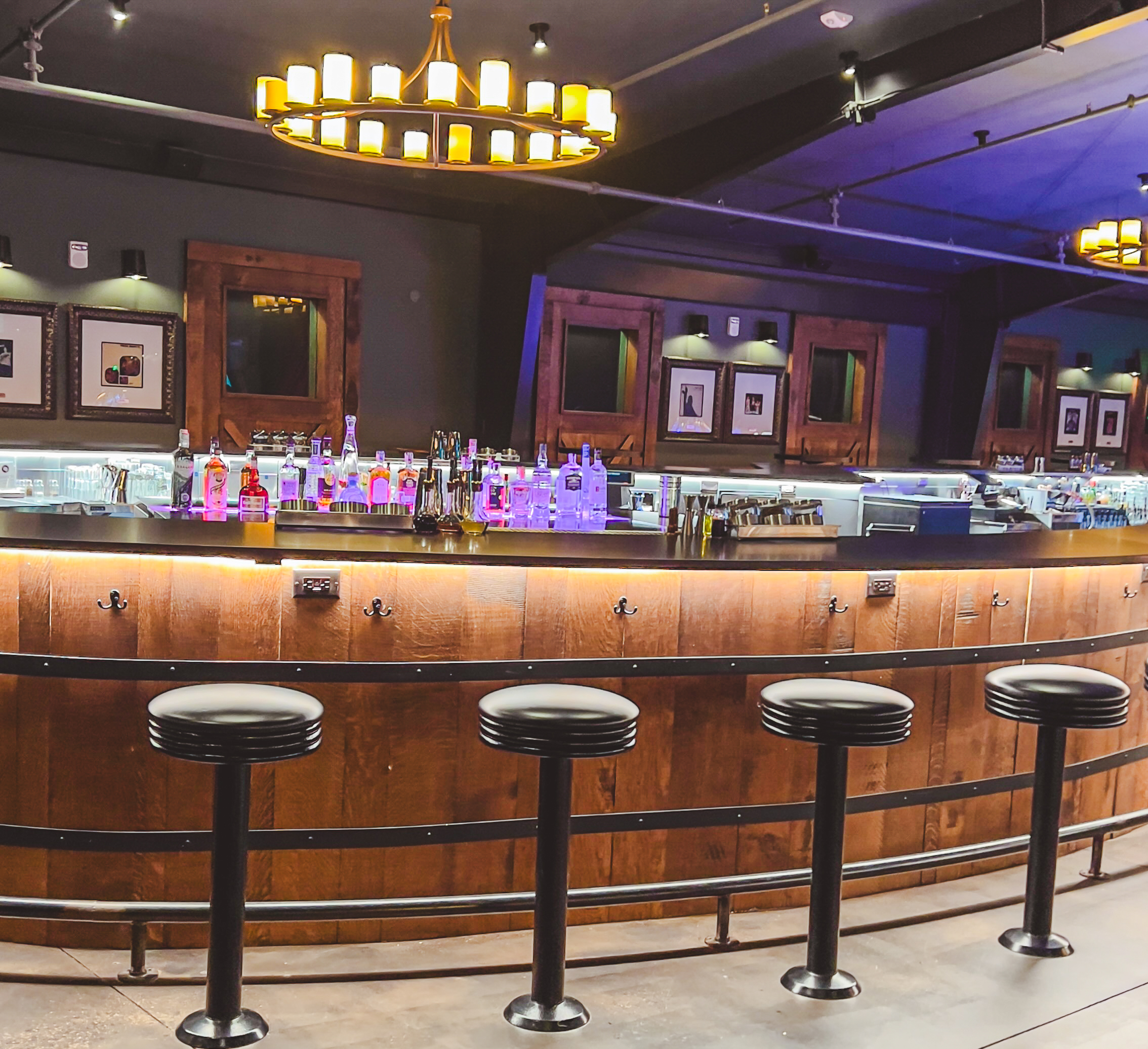 woman with a bob haircut holding a camera up to her face with a light in the background