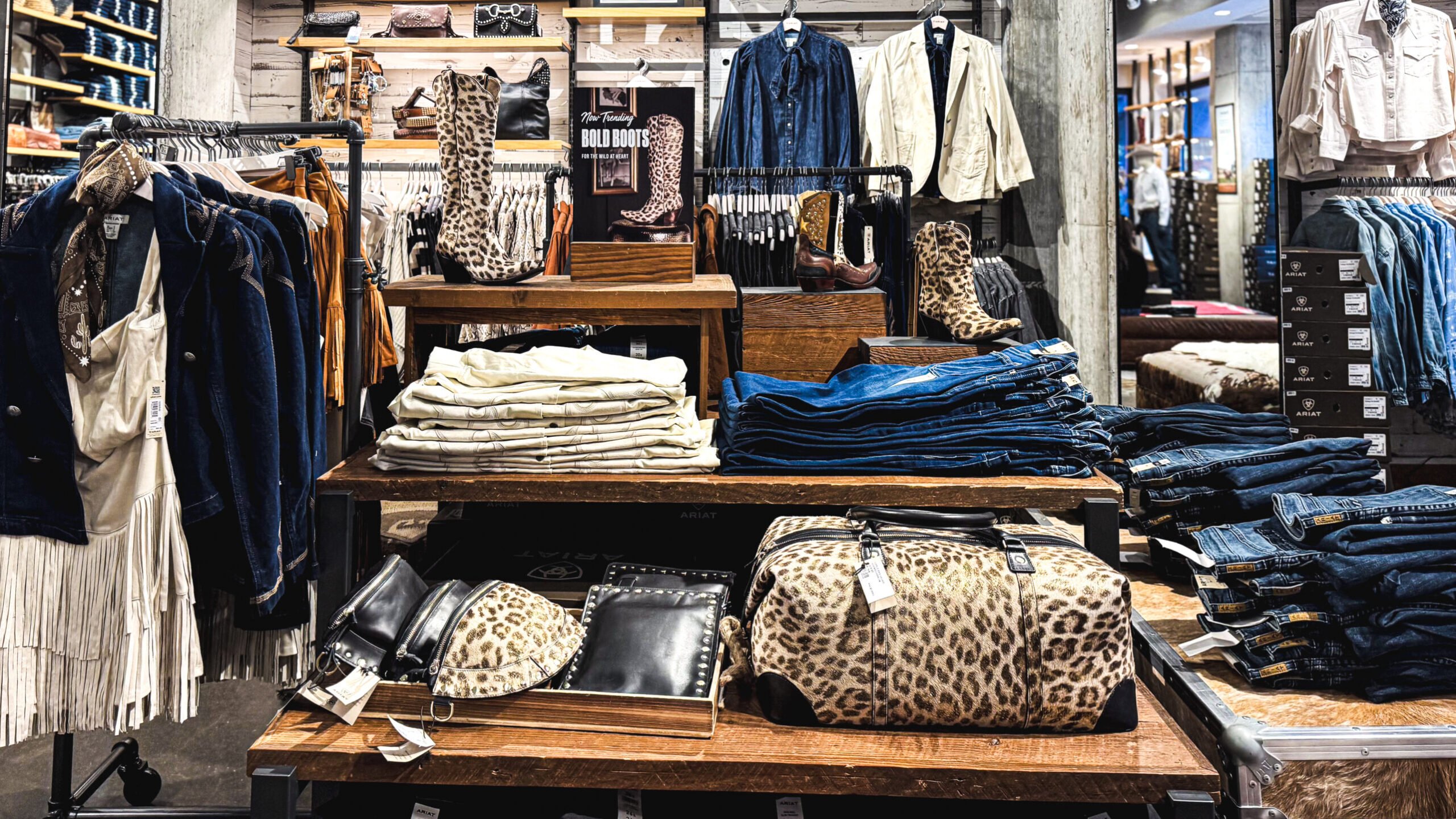 woman with a bob haircut holding a camera up to her face with a light in the background