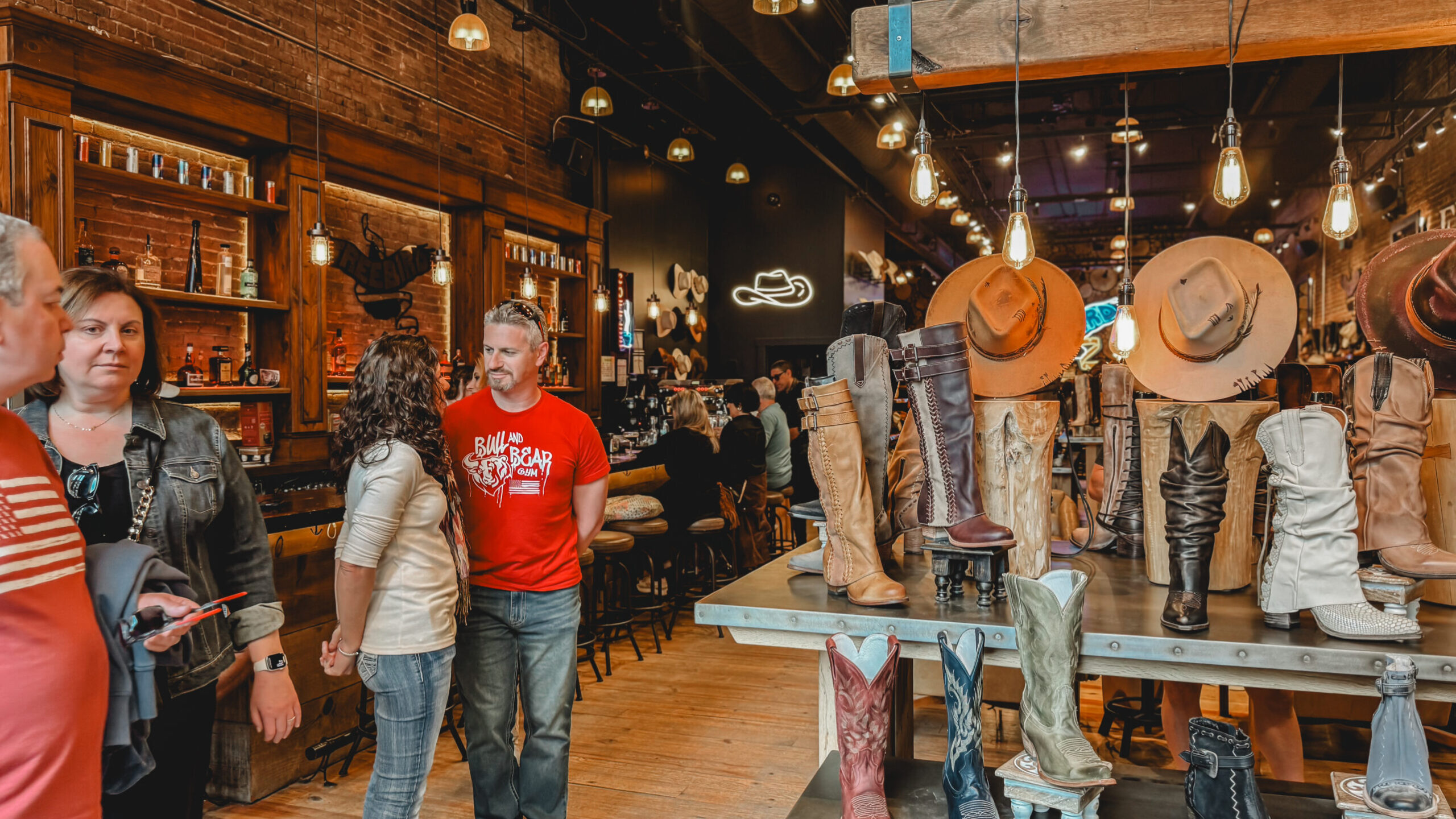 woman with a bob haircut holding a camera up to her face with a light in the background