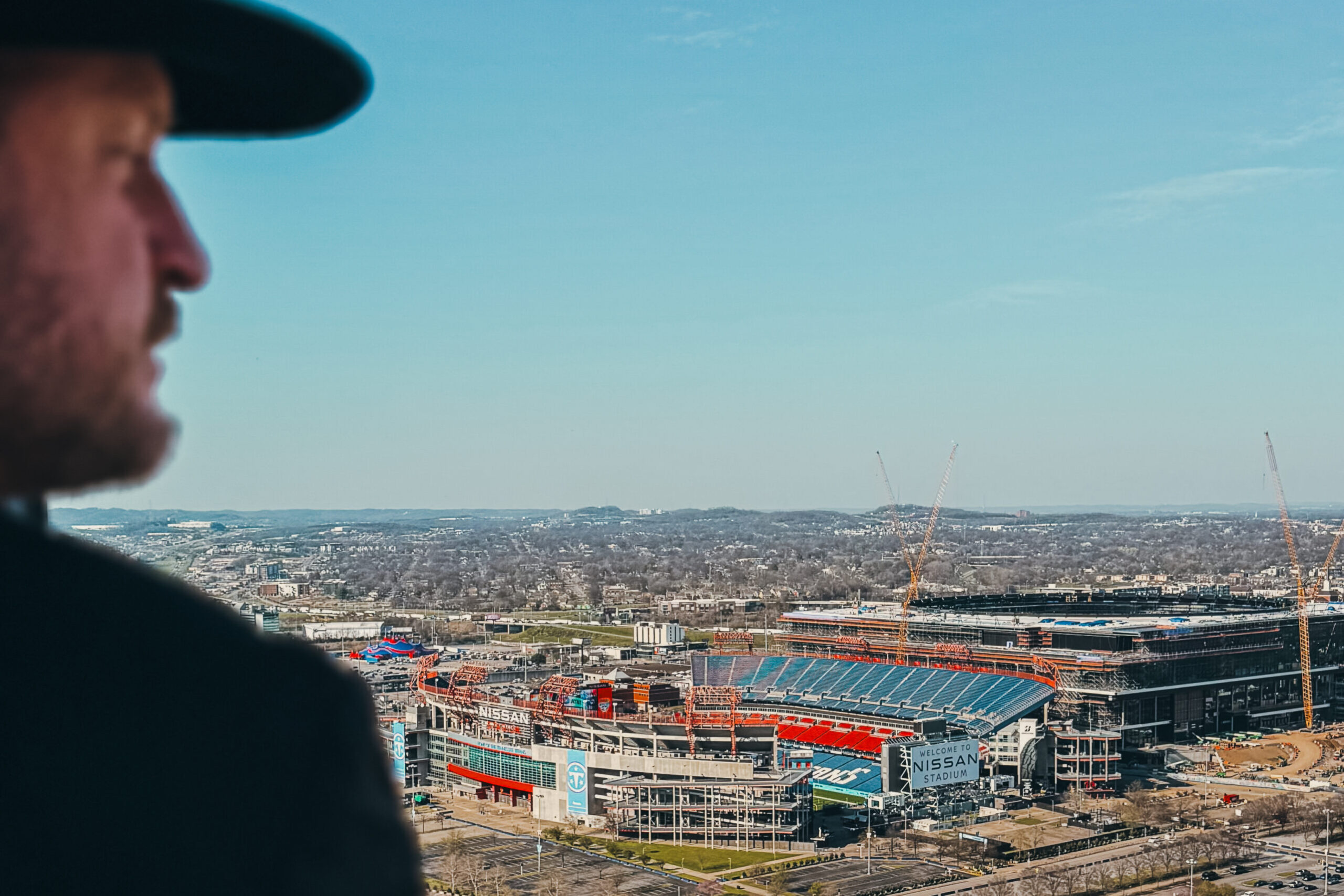 woman with a bob haircut holding a camera up to her face with a light in the background