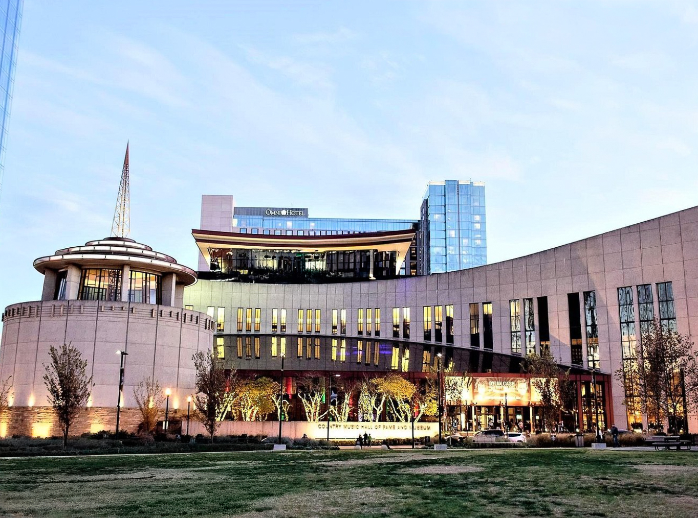 woman with a bob haircut holding a camera up to her face with a light in the background