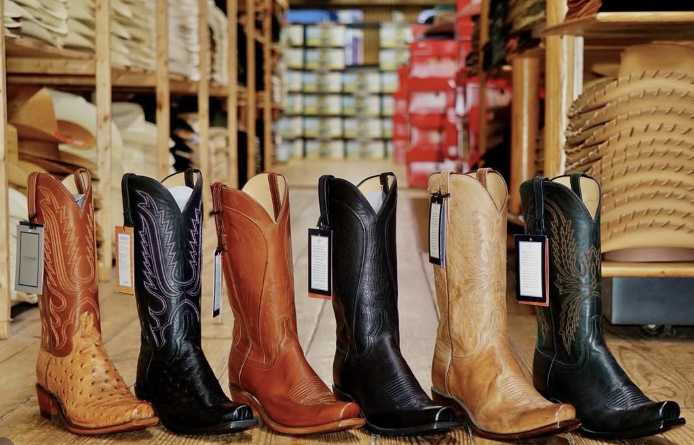 woman with a bob haircut holding a camera up to her face with a light in the background