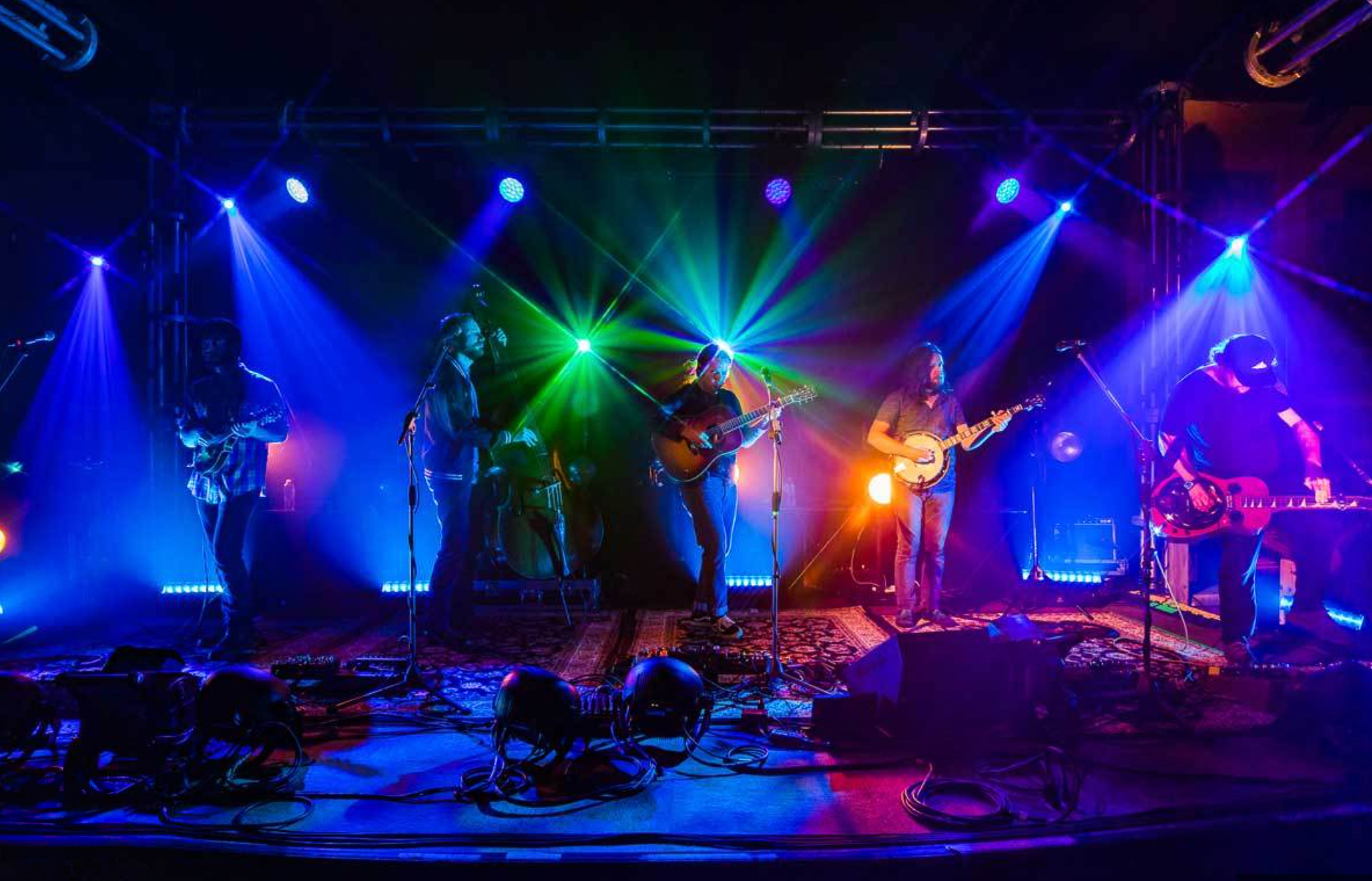woman with a bob haircut holding a camera up to her face with a light in the background